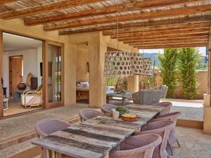 a wooden table and chairs on a patio at Kasbah 3 in Cala Vadella