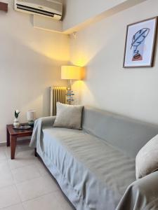 a bedroom with a bed and a table with a lamp at Almyra Home in Kyparissia