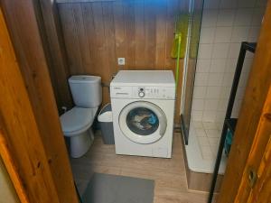 a small bathroom with a washing machine and a toilet at Laeva in Pärnu