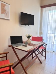 a laptop computer sitting on a table in a living room at Almyra Home in Kyparissia