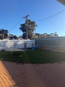 a yard with a playground with a swing at Lamington Guesthouse in Kalgoorlie +3 photos