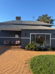 a house with a brick driveway in front of it at Lamington Guesthouse in Kalgoorlie