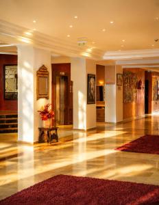 a lobby of a building with a vase of flowers at Kennedy Hospitality Resort in Marrakesh +127 photos