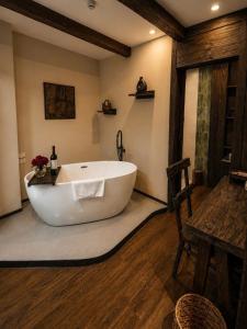 a large white bath tub in a room with a table at The Mysteri Sapa in Sapa +67 photos