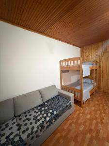 a living room with a couch and a bunk bed at Sun & Sea Shengjin in Lezhë