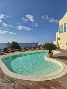 a swimming pool with the ocean in the background at Vinha da Areia Beach Hotel in Vila Franca do Campo