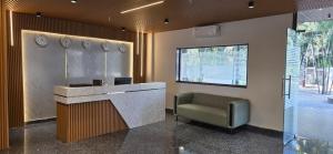 a lobby with a reception desk and a chair at Hotel Srs Manor in Hārohalli