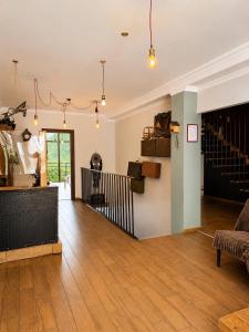 a living room with a wooden floor and a staircase at Chemodann Kazbegi in Kazbegi