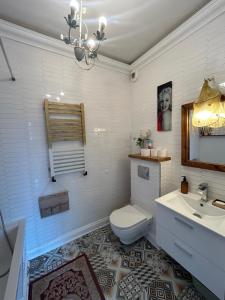 a bathroom with a toilet and a sink at Rooms in an Apartment with Beautiful Views in Przemyśl +44 photos