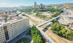 an aerial view of a city with a tall building at Hotel Santo Afonso in Aparecida