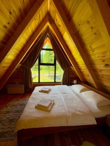 a bedroom with a large bed in an attic at A-frame Durmitor in Žabljak