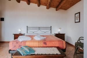 a bed with two pillows on it in a room at Dimora La Vignazza in Marzamemi
