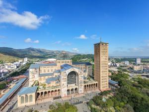 a large building with a cross on top of it at Hotel Santo Afonso in Aparecida