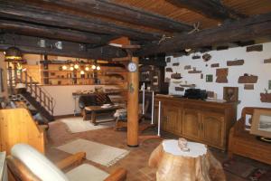 a living room with a table and a room with stairs at Ferienhaus Zum Herbertsche in Lemberg