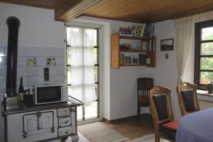a living room with a tv on a desk with a microwave at Ferienhaus Zum Herbertsche in Lemberg