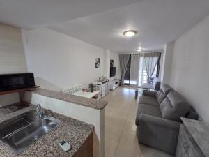 a kitchen and living room with a couch and a sink at Moncofa Beaches Apartment in Moncófar