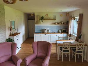 a kitchen and dining room with a table and chairs at Apartmán Zulu in Liptovský Mikuláš +8 photos