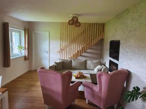 a living room with a couch and a table and chairs at Apartmán Zulu in Liptovský Mikuláš