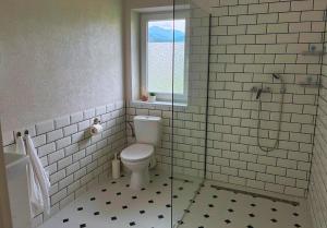 a bathroom with a toilet and a glass shower at Apartmán Zulu in Liptovský Mikuláš