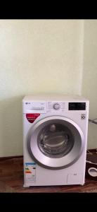 a white washing machine sitting next to a wall at Felt painting in Kara-Suu +13 photos