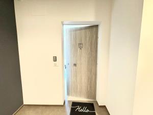 a hallway with a wooden door in a room at Mareka Luxury Apartments in Bari