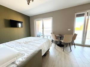 a bedroom with a bed and a table and chairs at Mareka Luxury Apartments in Bari
