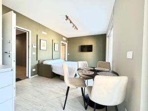 a bedroom with a bed and a table and chairs at Mareka Luxury Apartments in Bari +81 photos