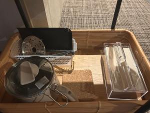 a wooden box with a mirror and other items in it at ホテル雅々音 in Sasebo