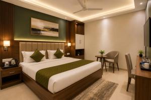 a hotel room with a bed and a desk at Hotel Starlin Near Delhi Airport & Free Airport pickup in New Delhi
