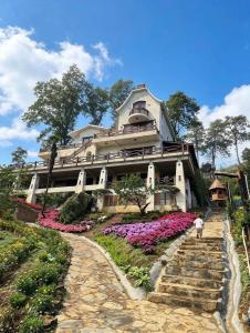 a large house with flowers in front of it at ALy's Sapa in Tả Van