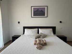 a bed with two pairs of slippers on it at Serendipity in Elmas