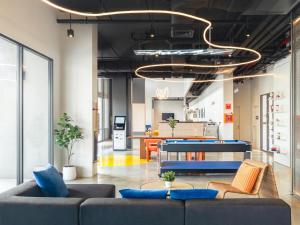 an office lobby with blue couches and a table at Bedz Hotel Ban Bueng in Ban Bung
