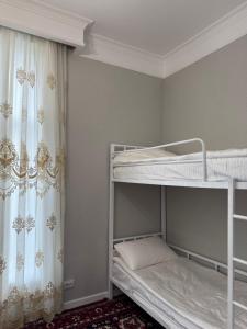 two bunk beds in a room with a window at Cottage on Issyk-Kul, Royal Beach in Chok-Tal +74 photos