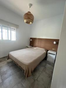 a bedroom with a large bed in a room at Casa Playa La Barrosa in Novo Sancti Petri