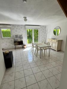a kitchen with a table and chairs in a room at Maison 3 chambres in Morlaix +8 photos