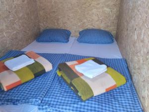 two beds with towels and pillows in a room at House&mini-Camp SKELICA in Neštin +22 photos