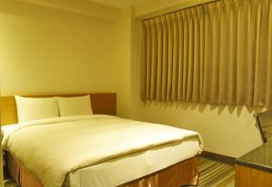 Voodi või voodid majutusasutuse Country Garden Hotel toas