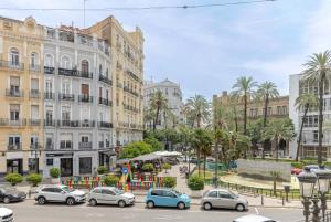 a city street with cars parked in front of buildings at Valencia Apartamentos Goya in Valencia