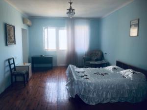 a bedroom with a bed and a chair and a window at Wild Caspian coast in Aşağıoba +22 photos