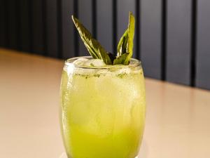 a yellow drink with a green plant in it at Ibis Styles El Malecon Guayaquil in Guayaquil