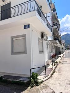 a white building with a window on the side of it at Almyra Home in Kyparissia