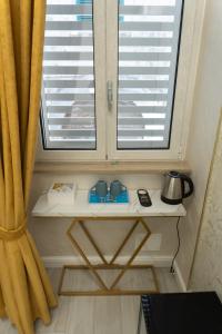a table in front of a window with two windows at Na Suite QuartieriSpagnoli in Naples