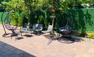 a group of chairs and a table on a patio at Appartaments Anna Kostava in Kobuleti +10 photos