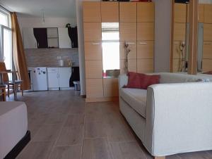 a living room with a couch and a kitchen at Latina lastva in Budva