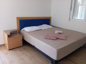 a bed with two pillows on it in a room at Latina lastva in Budva