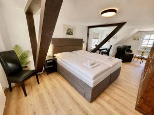 a bedroom with a large bed and a living room at Ferienhaus Maria in Warnemünde