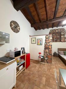 a kitchen and living room with a clock on the wall at DiVa in Castelnuovo di Farfa