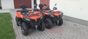 two orange atvs parked next to a building at Apartmani Hena in Sjenica +26 photos