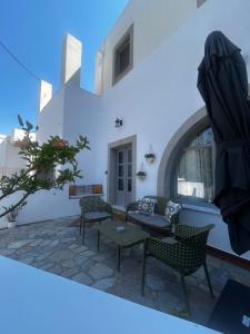 a patio in a house with chairs and a table at Mezzo Patmos Apartments in Patmos