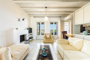 a living room with a couch and a table at Aurora by Mediterra in Isterni
